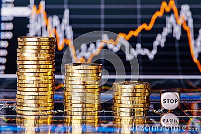 Downtrend financial chart, stacks of golden coins and dices cube Stock Photo