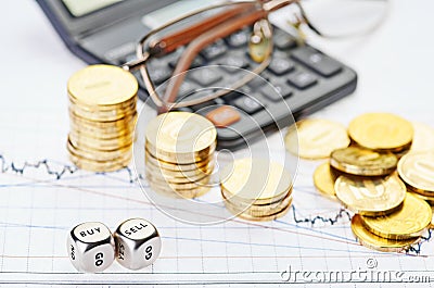 Downtrend stacks coins, calculator, glasses and dices cubes Stock Photo