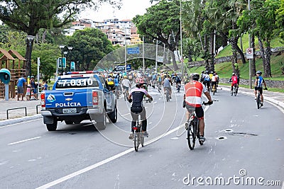 Dozens of cyclists are seen accompanied by a Bahia Military Police car touring the streets of the city of Salvador Editorial Stock Photo