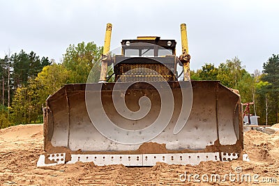 Dozer at road construction and bridge projects in forest area. Heavy machinery for road work. Building a road works. Bulldozer on Stock Photo