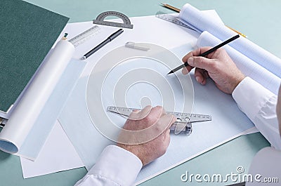 Drafter at work.Workplace of draftsman. Y-square, graph paper, rulers, pencils and different documents on the desktop Stock Photo