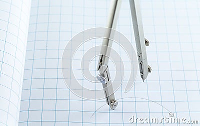 Drafting Compass on Checkered background Stock Photo