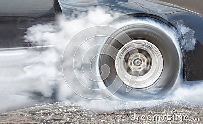 Drag racing car burns rubber off its tires for race Stock Photo