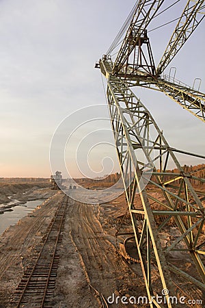 A dragline excavator and a stacker in a sand quarry. Old abandoned railway track. Phosphorite Mine Stock Photo