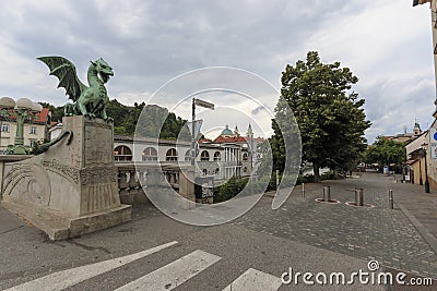 Dragon bridge in the center of Ljubljana and several tourists passing by Editorial Stock Photo
