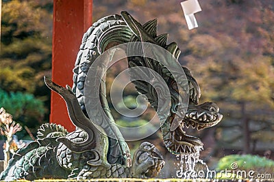Dragon at Chozuya or Temizuya (Water ablution pavilion) of Kitaguchi Hongu Fuji Sengen Jinja shinto shrine. Editorial Stock Photo