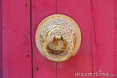 Dragon knocker on the chinese red door Stock Photo