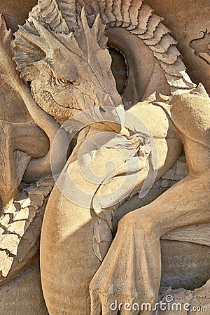 Dragon protects mermaid as a sculpture in the sand Editorial Stock Photo