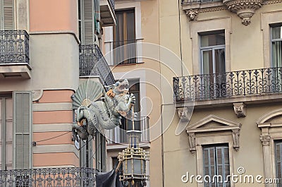 Dragon Statue on Street Corner La Rambla Barcelona, with an oriental fan on it. Editorial Stock Photo