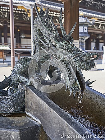 A dragon supplying water at purification fountain. Stock Photo