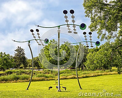 `Dragonflies`, a kinetic sculpture by David Hickman in the Arlington Sculpture Garden at Meadowbrook Park. Editorial Stock Photo