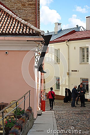 drain in the form of a boot on the old streets of medieval Tallinn Editorial Stock Photo