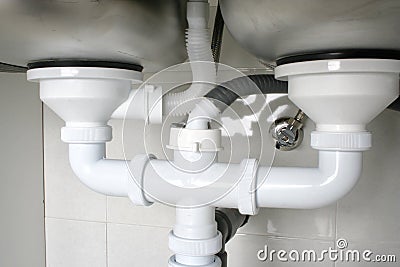 Drain pipes of a kitchen sink with dishwasher connection Stock Photo