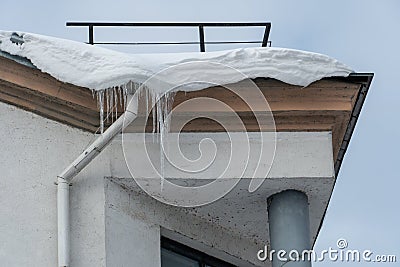 The drainpipes are covered with ice and snow. After a heavy snowstorm, the city is covered with snow and ice. There are many Stock Photo