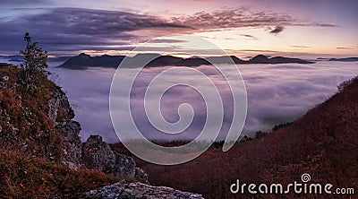 Dramatic autumn sunrise in mountain with red sky and clouds Stock Photo