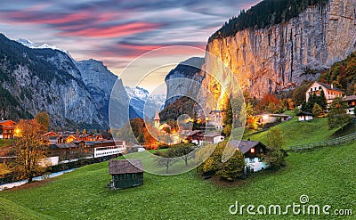 Dramatic autumn view of Lauterbrunnen valley with gorgeous Staubbach waterfall and Swiss Alps at sunset time Stock Photo