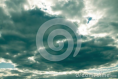 Dramatic beautiful sky with overcast clouds hiding the sun Stock Photo