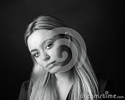 Dramatic black and white portrait of a beautiful woman on a dark background Stock Photo