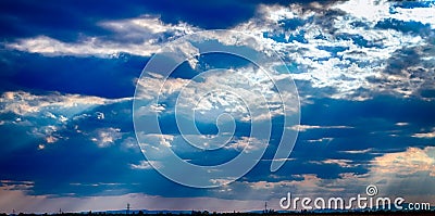 dramatic blue sky with clouds and sun rays Stock Photo