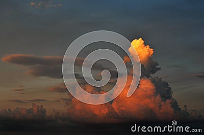 Dramatic cloud reflecting sunset Stock Photo