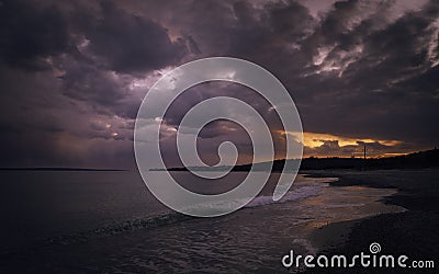 Dramatic overcasting dark clouds over beach on Cape Cod in summer Stock Photo