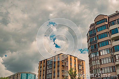 Dramatic cloudy gray city living apartments buildings perspective urban view with moody sky background, copy space Stock Photo