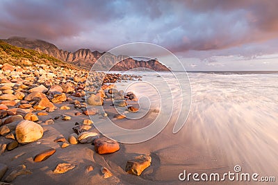 Stormy seascape with water rushing onto the beach. Stock Photo