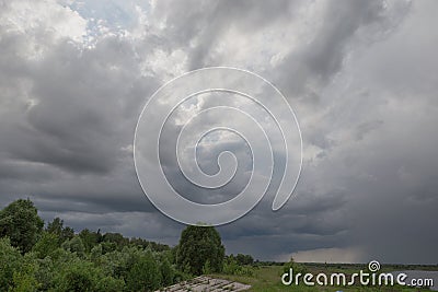 Dramatic countryside landscape with thunderclouds in the sky over a wheat field Stock Photo