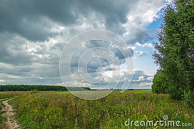 Dramatic countryside landscape with thunderclouds in the sky over a wheat field Stock Photo