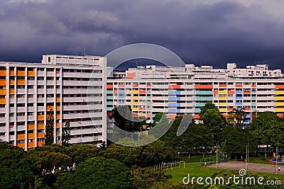 Dramatic dark grey clouds over colourful HDB flats in Singapore heartland Stock Photo