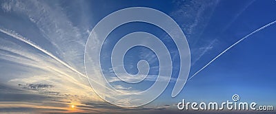 Dramatic dinamic evening blue sky with sun and white cloud Stock Photo