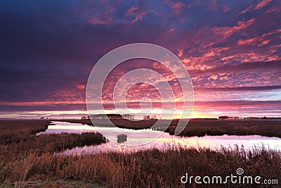 Dramatic fire sunrise over river Stock Photo