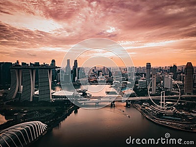 Dramatic HDR Aerial Drone Shot of Singapore Skyline, harbour, stadium, Marina Bay and gardens by the bay during Sunset. Stock Photo