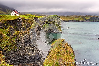 Icelandic landscape, lonely house on the volcanic cliffs seacoast, Arnarstapi, Snaefellsnes peninsula, Iceland Stock Photo