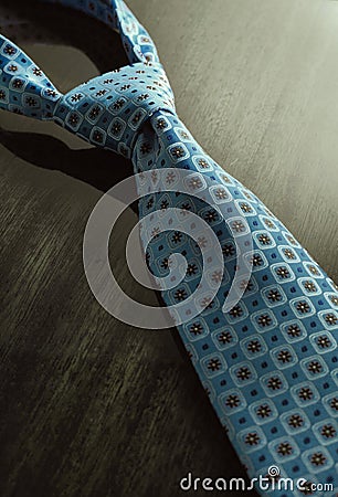 Dramatic image of necktie on the wooden table Stock Photo