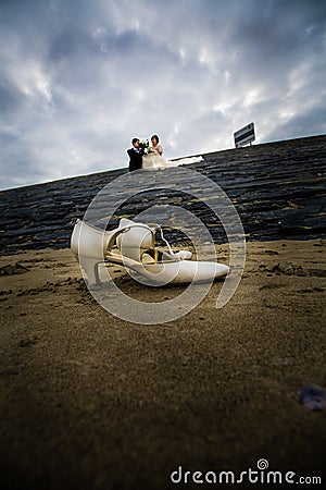 Beachfront Nuptials: Bridal Shoes and Seaside Vows Stock Photo