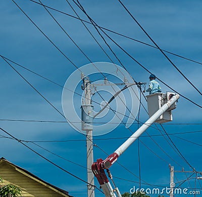 Dramatic image of power line workers in the caribbean, dominican republic. Editorial Stock Photo