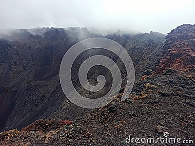 Dramatic landscape : Dolomieu crater in cloudy weather, piton de Stock Photo