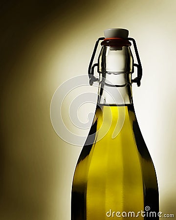 Warm light glows through virgin olive oil in a transparent glass bottle Stock Photo