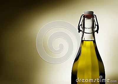 Warm light glows through virgin olive oil in a transparent glass bottle Stock Photo