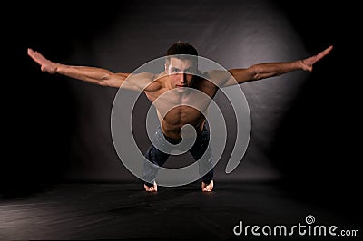 Dramatic light photo of modern acrobat Stock Photo