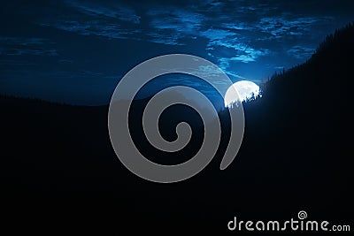 Dramatic Nighttime Moonrise Over Mountain Ridge and Pine Trees Stock Photo