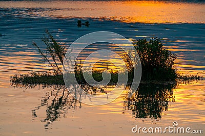 Dramatic panorama evening sky and clouds over mountain and lake at sunset Stock Photo