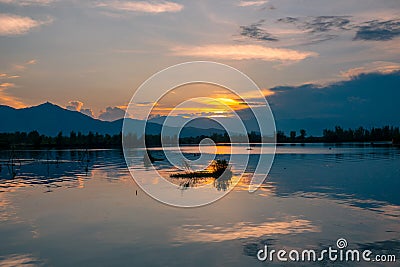 Dramatic panorama evening sky and clouds over mountain and lake at sunset Stock Photo