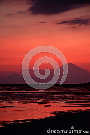 Pink sunset with mount Agung silhouette landscape portrait, Bali Indonesia. Stock Photo