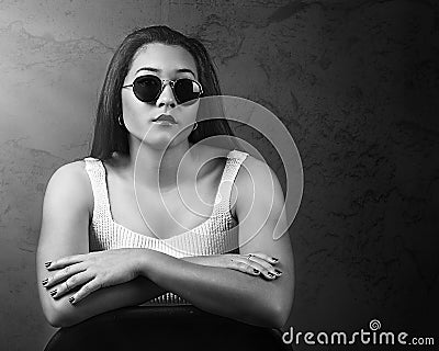 Dramatic portrait of beautiful Pacific Islander woman wearing sunglasses Stock Photo