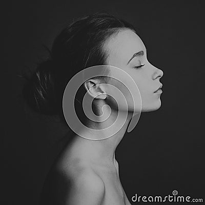 Dramatic portrait of a girl theme: portrait of a beautiful girl on a dark background in studio Stock Photo