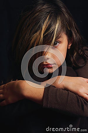 Dramatic portrait of a serious dark haired girl Stock Photo