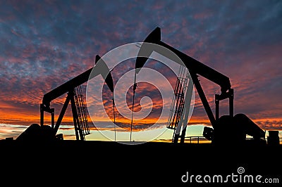 Dramatic Sky Over Pumpjack Silhouettes in Rural Alberta, Canada Stock Photo