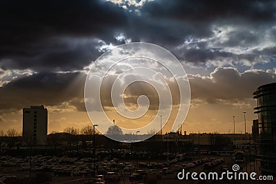 Dramatic sky with rays of sun over city Stock Photo